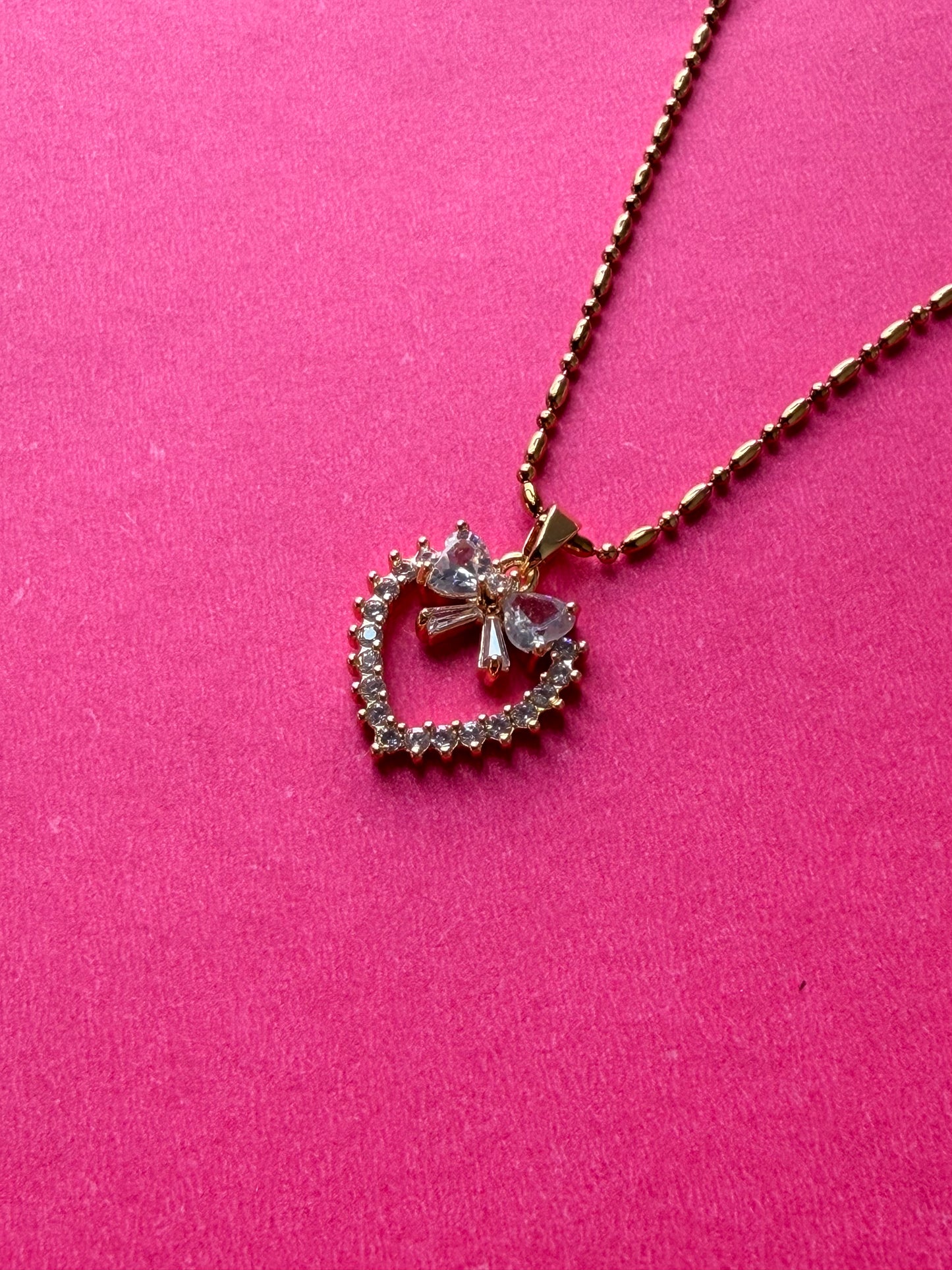 Bow-Accented Radiant Heart pendent